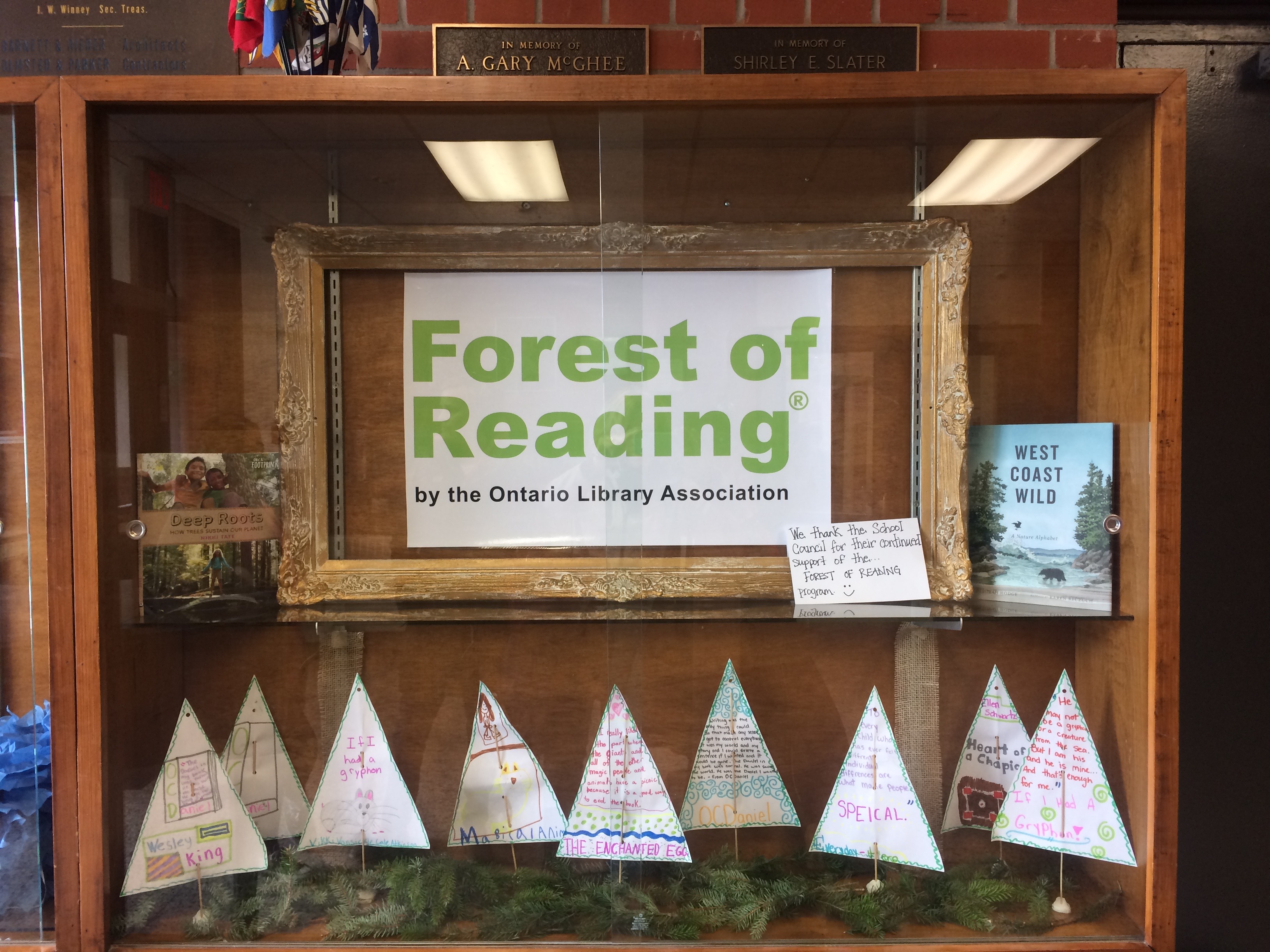 display case with Forest of Reading banner and trees