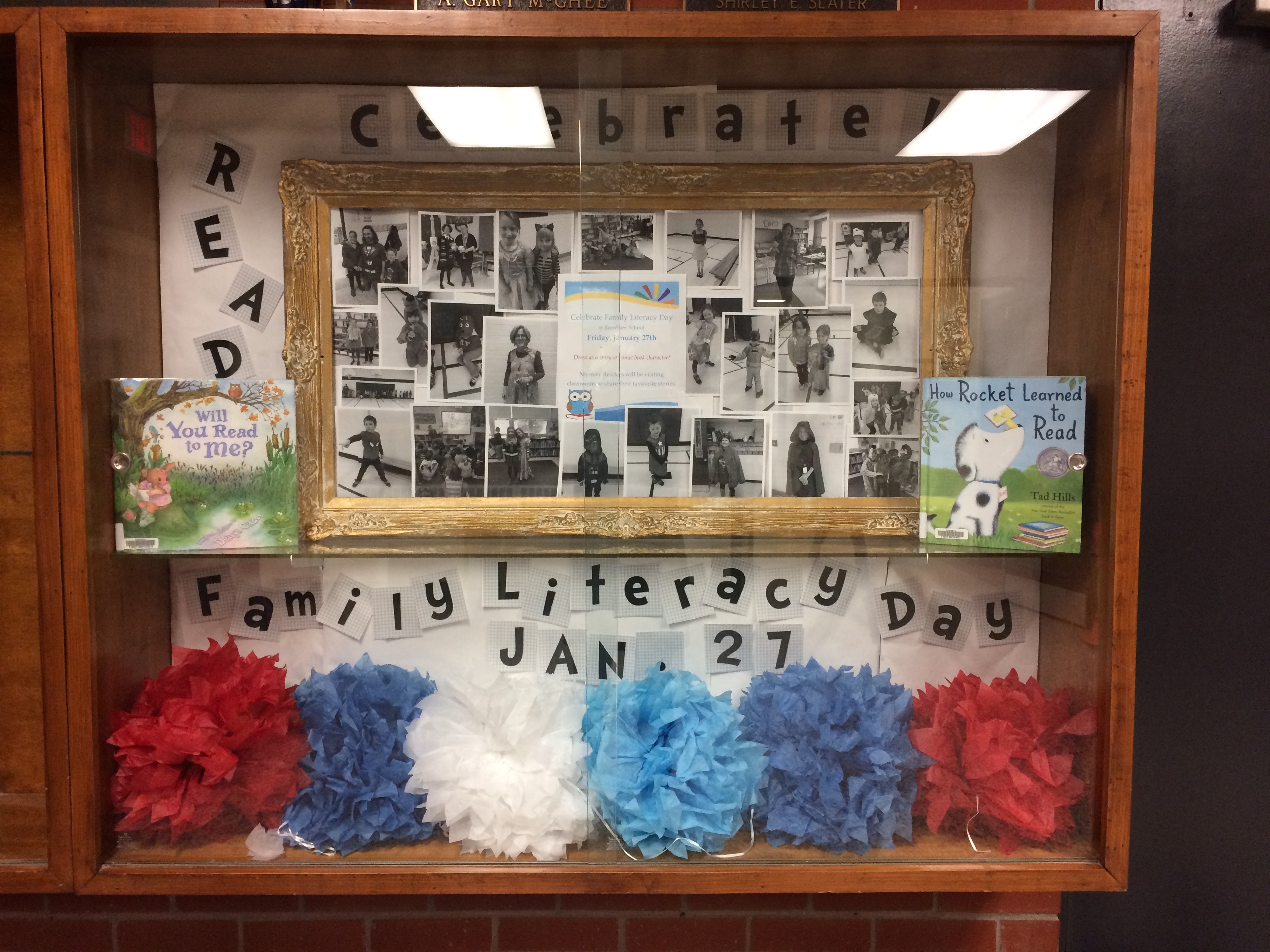 display case with Family Literacy Day pictures and books